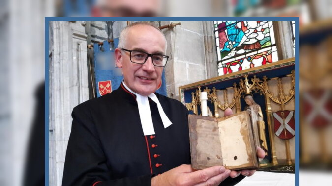 Rev Canon Keith Farrow mit dem alten Buch. Quelle: thestar.co.uk